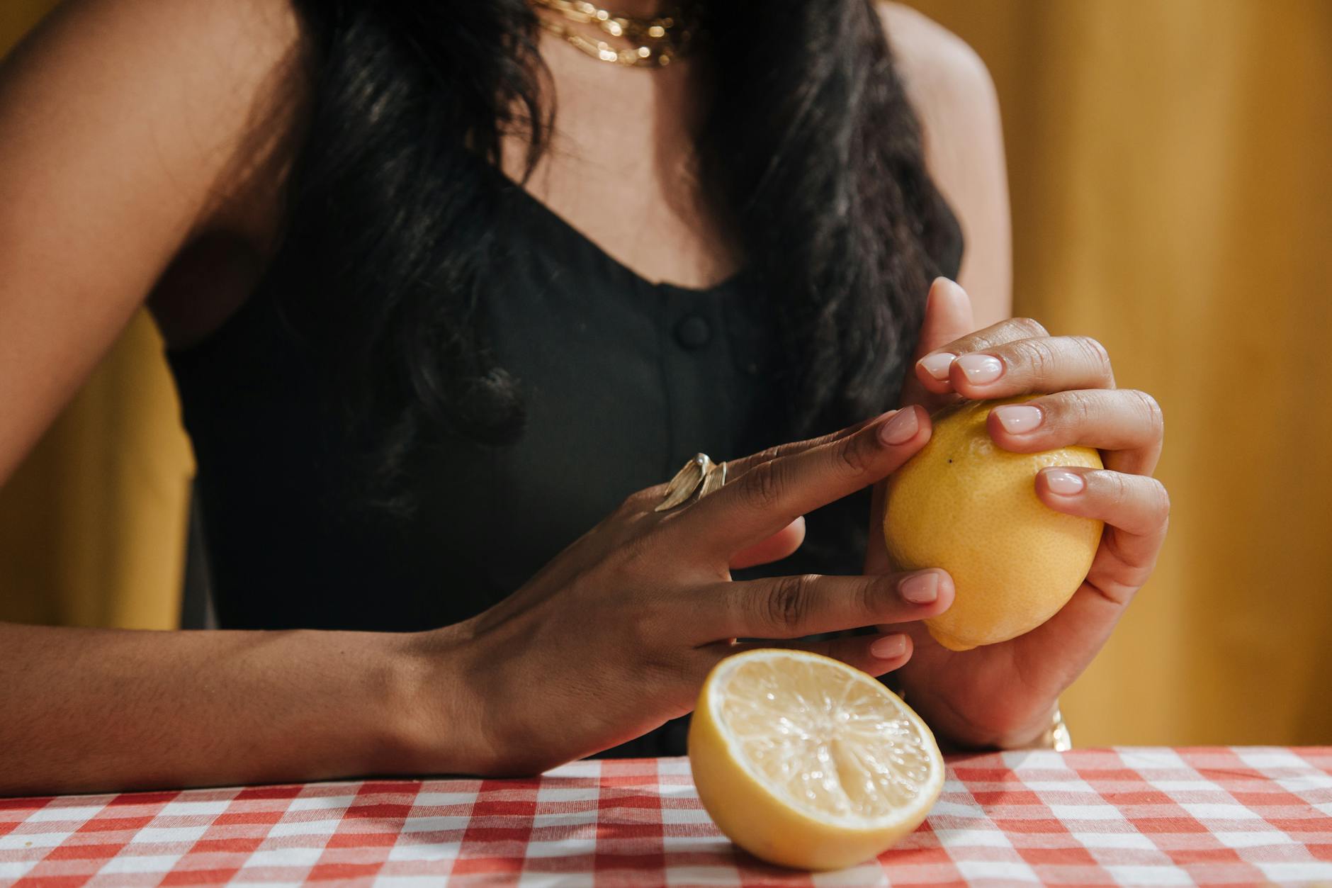 Two hands holding fresh lemons, symbolizing shared pleasure and intimate connection