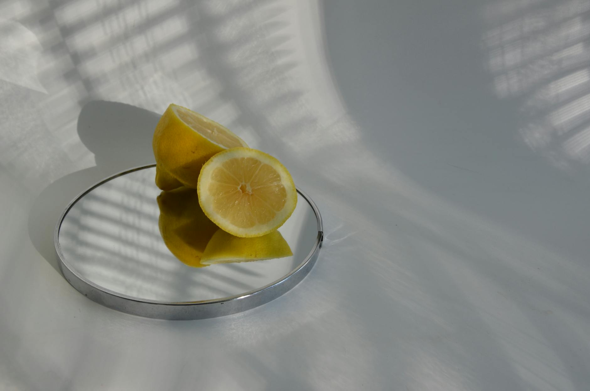 A lemon-colored vibrator resting on soft white fabric, ready for intimate use